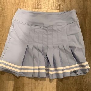 Blue and white pleaded skirt in the front and regular skirt In the back